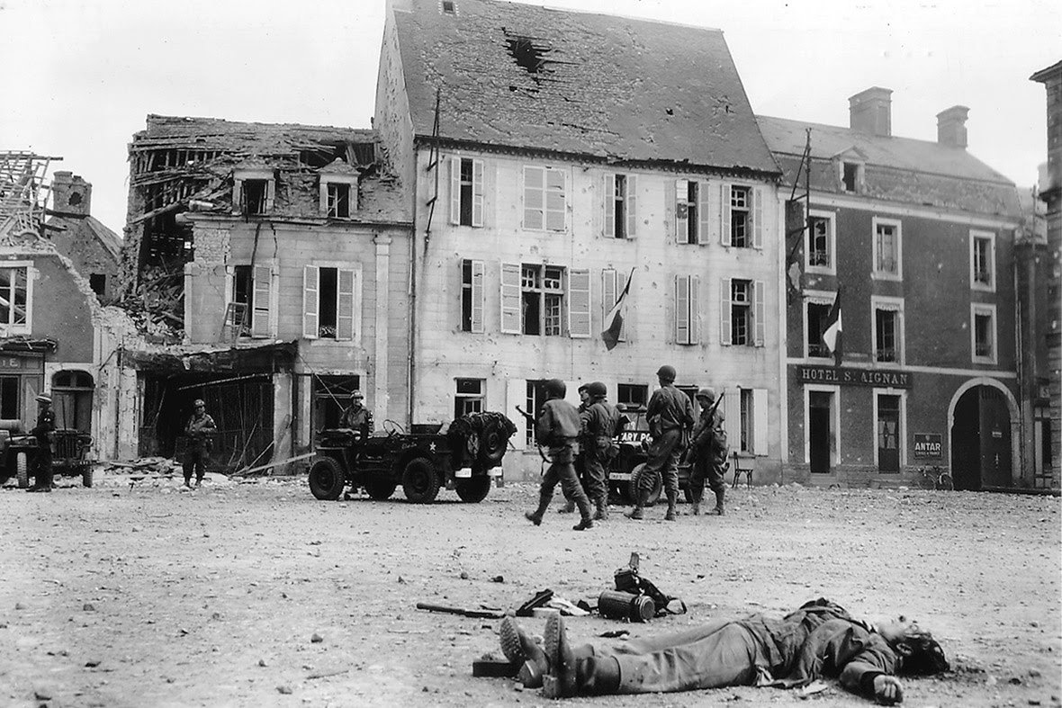 June 15, 1944: The body of a dead German soldier lies in the main square of Place Du Marche in Trevieres after the town was taken by US troops who landed at nearby Omaha Beach