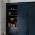 Navy Blue Kitchen Cabinets With Black Hardware - In this 1970s inspired cooking space by architecture and interior design practice atticus & milo, a kitchen island and upper cabinets both in yellow offset the dark walls.