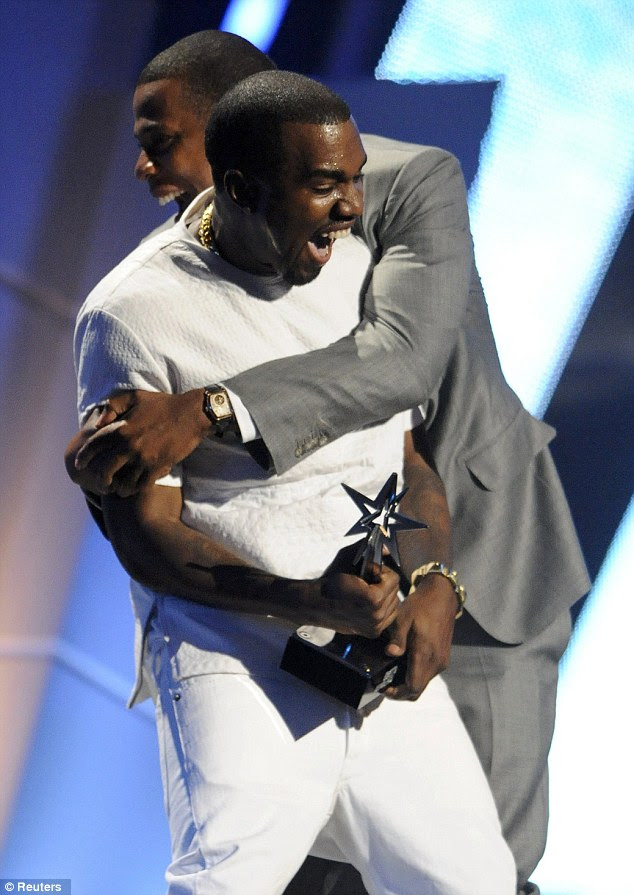 Moment of glory: Kanye West and Jay-Z embrace as they accept award for Best Group