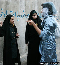 Police confront a woman contravening strict dress codes