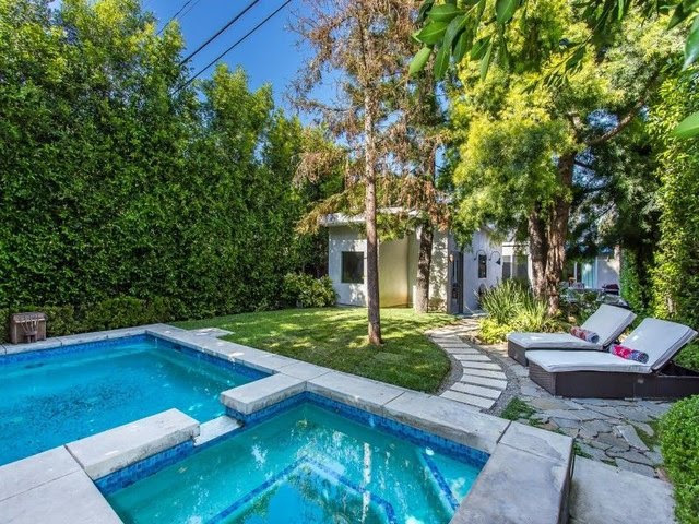 The back yard includes a pool and spa