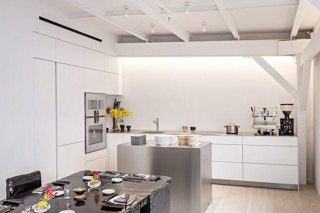Stephanie Goto’s kitchen has white laminated Bulthaup cabinets and Gaggenau appliances. The layout optimizes efficiency and easy access to tools and appliances. The island conceals stacked drawers.