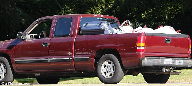 Heavy haul: R-Patz looked upset as he left his Twilight co-star's home with what appeared to be all of his things