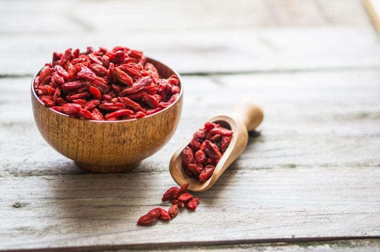 Goji berries on wooden background