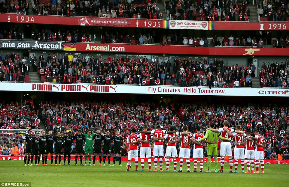 Burnley and Arsenal players observe a minute's silence before the game to in a show of respect for those who have fallen in conflict