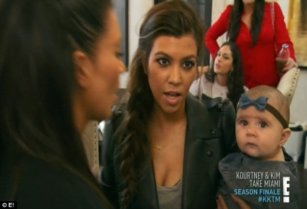 California-bound: Kourtney held on to daughter Penelope before they headed back to Los Angeles