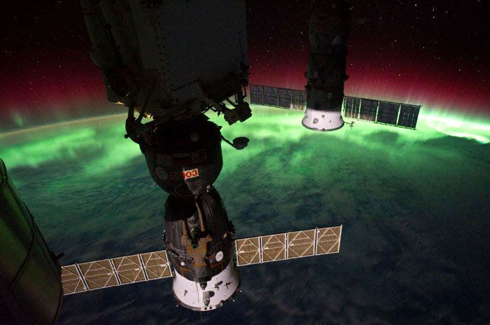 Two Russian Soyuz spacecraft are backlit by auroras in this image taken by ISS commander Mike Fossum.