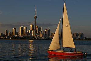 Sailboat passes in front of the Toronto skylin...