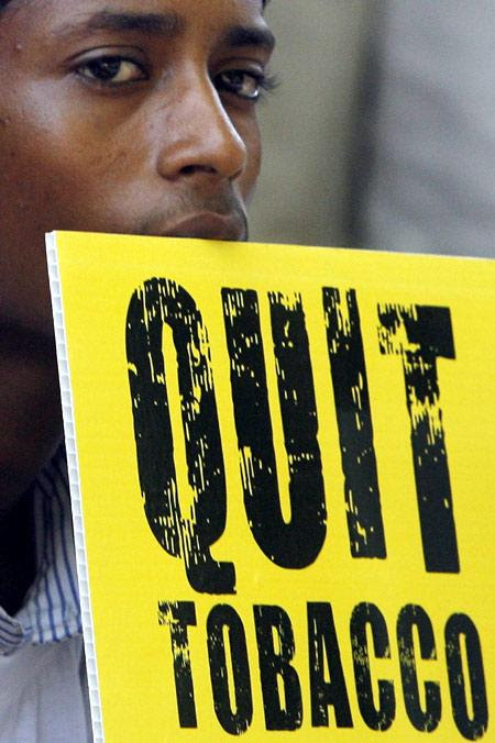 A student holds a placard during an anti-tobacco awareness campaign on the eve of World No Tobacco Day in Mumbai.