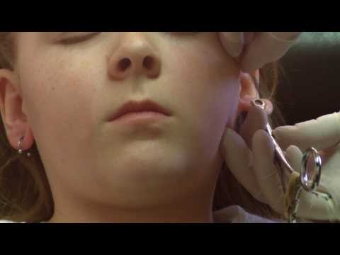 9 year old Sunny gets her ears pierced the right way by a professional body 