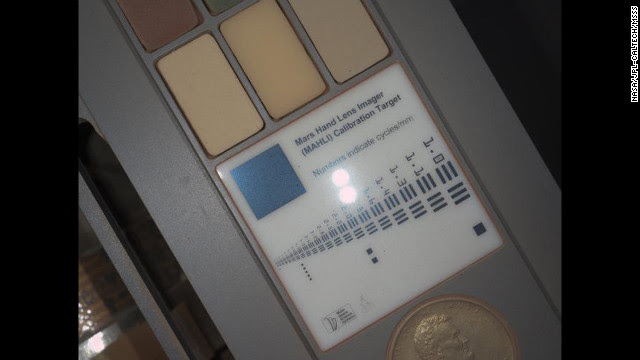 Other night photos includes this image of the calibration target for the Mars Hand Lens Imager camera at the end of the rover's robotic arm. For scale, a penny on the calibration target is three-fourths of an inch in diameter. 
