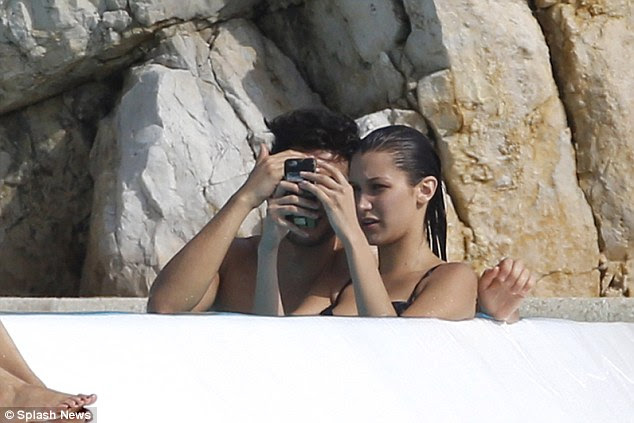 Inspecting their handiwork: The pair were seen checking out their snaps, which will no doubt appear on social media