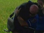 Hero: Police officer Nick Ague carrying Mya the German Shepherd to safety