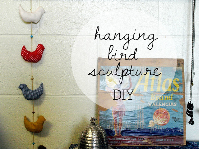 hanging bird sculpture badge