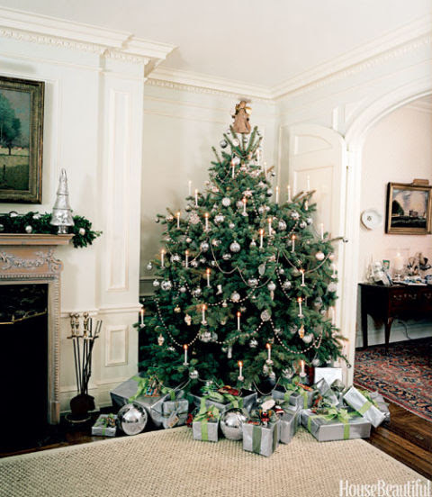 Real candles give the Christmas tree in artist Clare Potter's home an old-fashioned charm, but for safety reasons you should use lights at home; all-silver ornaments from Williams-Sonoma Home delight the eye. 
