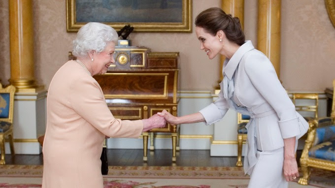 .Angelina Jolie is greeted by the Queen at Buckingham Palace.