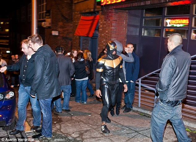 It is when he walks by night that he stumbles... Phoenix Jones patrols the streets of Seattle (on foot) on January 9. He is part of the Rain City Superhero Movement