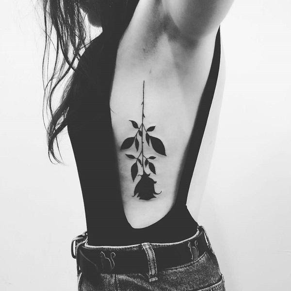 flower tattoo on side of body