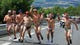 Race supporters in their underpants run on the course in front of the peloton during stage 14 of the Tour de France.