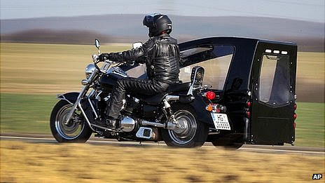 Joerg Grossmann rides his Kawasaki VN 1500 fitted with a sidecar hearse