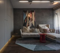 The small living room offers enough space for this minimalist sofa and chaise, but it's the Flos Toio lamp in the corner that you can't help but notice.