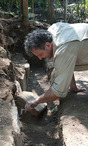 Marcello A. Canuto, director of Tulane's Middle American Research Institute, examines hieroglyphics at the La Corona dig site in Guatemala 