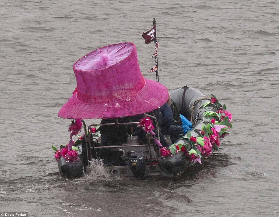 Dressed to impress: As the rain fell, this oversized hat on one of the boats in the thousand strong flotilla came in rather handy to shelter from the weather
