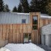 house in madesimo, ES-arch, Consalez Rossi Architetti Associati, zinc roof, lopsided roof, asymmetric roof, Rheinzink, untreated wood, larch, precast concrete panels, guest home, Madesimo, stone passageway, gray gneiss split stone