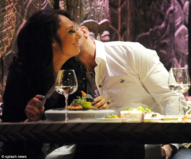 Nuzzle: Alex kissed his girlfriend's neck while she tried to eat her dinner 