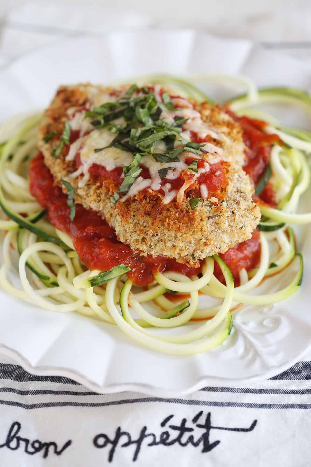 This recipe for Baked Chicken Parmesan with Zucchini Noodles is healthy, delicious and can easily be made in just 30 minutes or less!