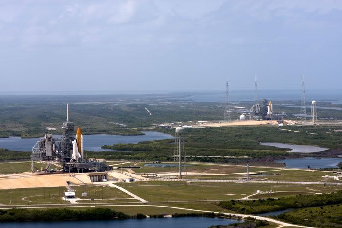 Space shuttle Endeavour (background) joins her sister Atlantis (foreground) at Launch Complex 39, on April 17, 2009.