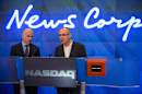 Robert Thomson, right, CEO of News Corp, and Gerard Baker, editor in chief of the Wall Street Journal, at the opening bell of the Nasdaq exchange in July.