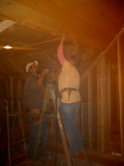 Braun assists Adam with some ceiling installation