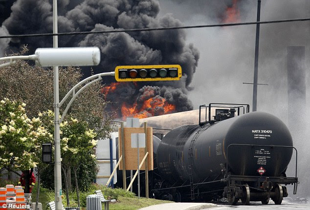 Still burning: Flames and smoke pour from one of the wagons hours after the derailment