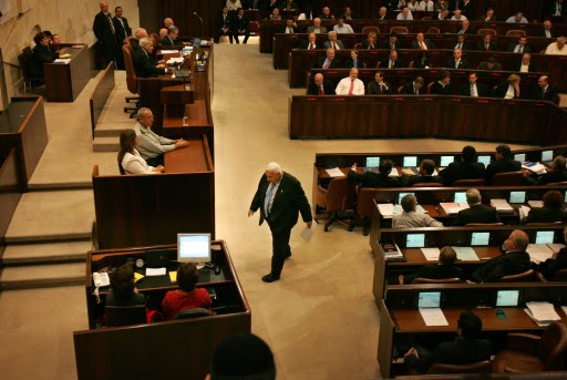 FILE - In this Monday, Oct. 31, 2005 file photo, Israeli Prime Minister Ariel Sharon walks before delivering a speech at the opening of the winter session of the Knesset, Israel's parliament, in Jerusalem. The son of former Israeli Prime Minister Ariel Sharon says his father has died on Saturday, Jan. 11, 2014. The 85-year-old Sharon had been in a coma since a debilitating stroke eight years ago. His son Gilad Sharon said: "He has gone. He went when he decided to go."  (AP Photo/Oded Balilty, File)