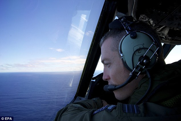 Authorities say unidentified material that washed ashore in southwestern Australia is being examined for any link to the lost Malaysian plane.