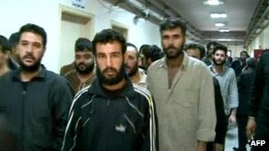 A handout picture released by the Syrian Arab News Agency (Sana) shows prisoners being released from an unidentified prison in Damascus (30 November 2011)