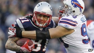 New England Patriots tight end Aaron Hernandez (81) tries to break free of Buffalo Bills linebacker Chris Kelsay (90) during the fourth quarter of an NFL football game in Foxborough, Massachusetts 1 January 2012