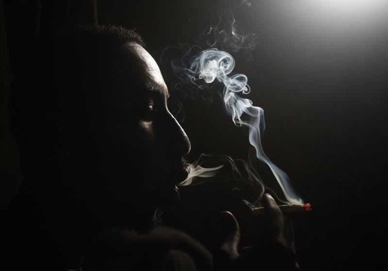 A heroin addict smokes heroin in Lamu November 21, 2014.  REUTERS/Goran Tomasevic 