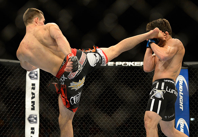 SEATTLE, WA - JULY 27: (L-R) Rory MacDonald kicks Jake Ellenberger in their welterweight bout during the UFC on FOX event at Key Arena on July 27, 2013 in Seattle, Washington. (Photo by Jeff Bottari/Zuffa LLC/Zuffa LLC via Getty Images) *** Local Caption *** Rory MacDonald; Jake Ellenberger