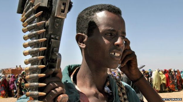 A Somali militant talks on a mobile phone 