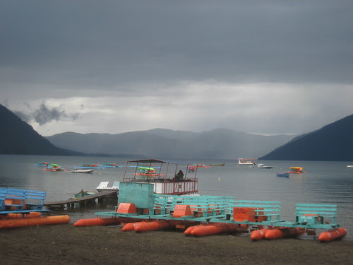 Colorful boats on rainy lake