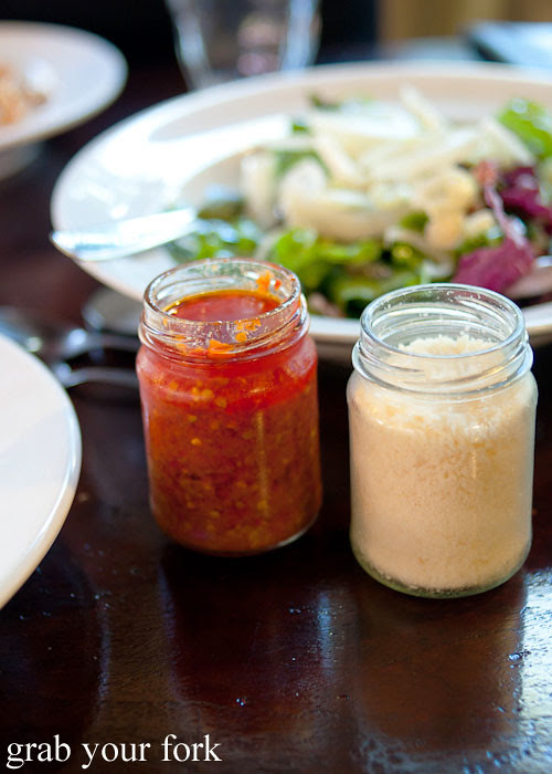 chilli sauce and parmesan cheese at pasta emilia surry hills