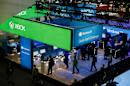 People walk through the Microsoft booth at the Game Developers Conference, Wednesday, March 4, 2015, in San Francisco. (AP Photo/Eric Risberg)