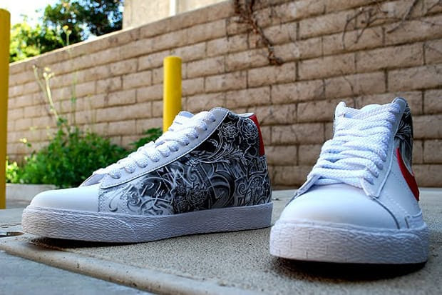 The kicks feature a mostly white base with red accents and black/white 