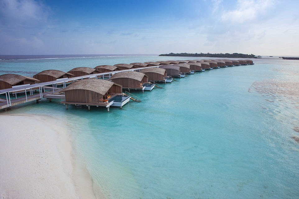 Room with a view: Solar panels - fitted above the walkways to and from the jetty and leading to the arc of over-water villas - provide the electricity for the island