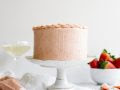 Champagne and Strawberries Cake by Wood and Spoon blog. This is a simple champagne scented layered cake topped with a real strawberry American buttercream and made extra moist with a champagne simple syrup. Two layers make up this small 6" cake which is perfect to gift or share with a valentine. Learn how to make this romantic date night in cake on thewoodandspoon.com