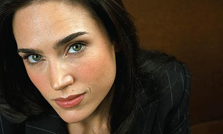 With her jet-black hair parted almost in the centre, black cardigan and pale 
