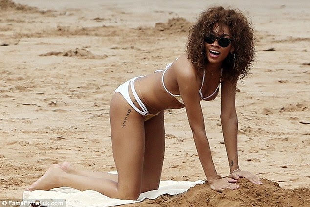Child's play: Bria seemed to be building a large sandcastle as she got to work on the beach