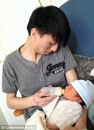 Victim: Her partner Geng Liu with baby Lucas, who was warned after the crash he might have to choose between his girlfriend's life or his son's